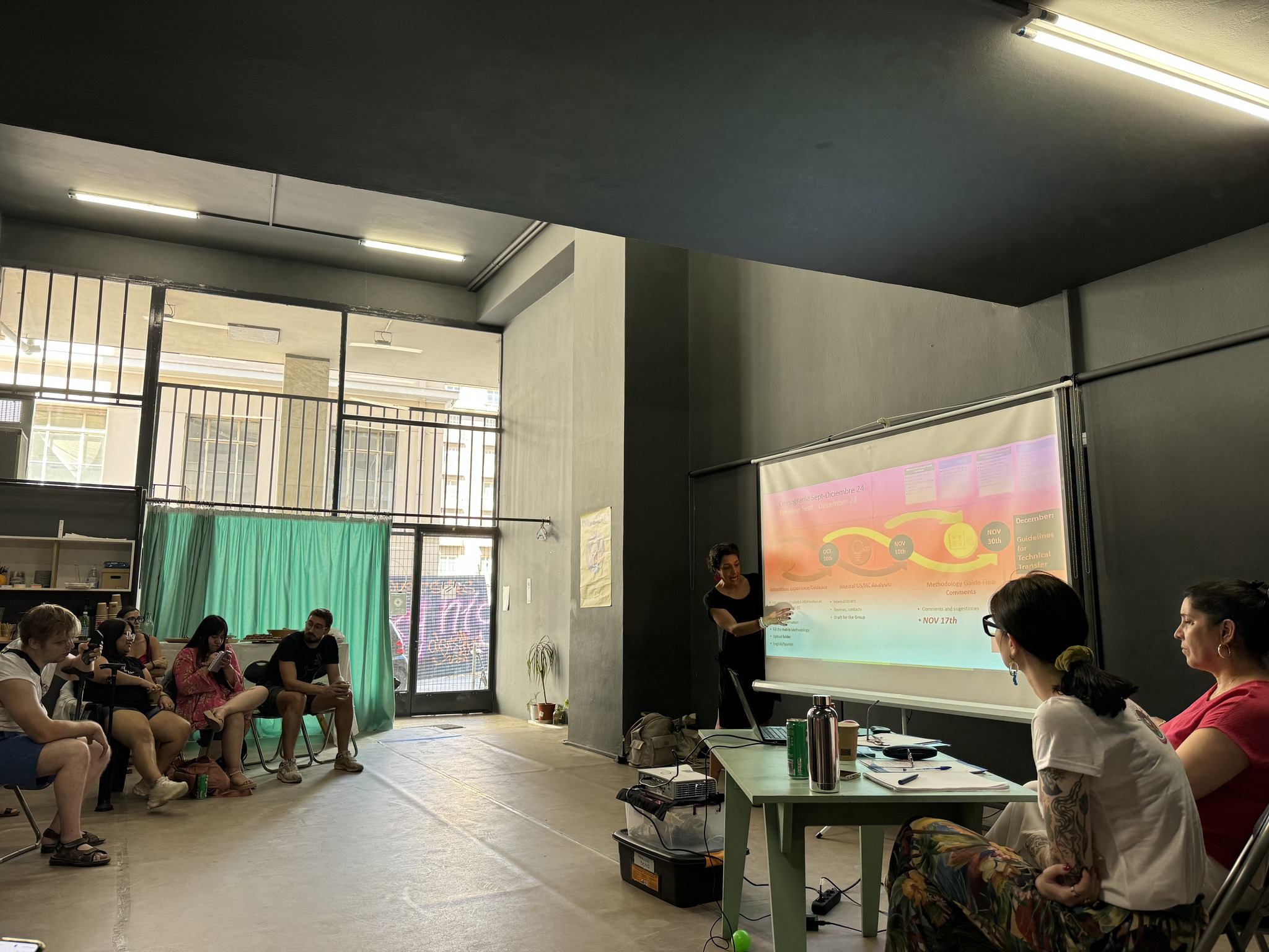 a group looking at the screen of the projector in a meeting